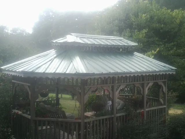 Two tier green metal roof on a garden gazebo in Mineral Springs